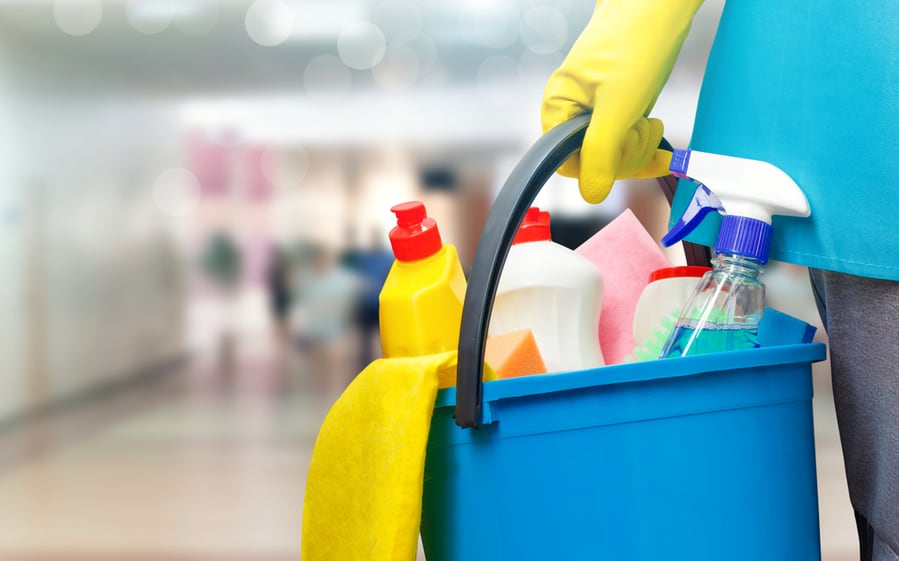 Cleaning Lady With A Bucket And Cleaning Products On Blurred Background