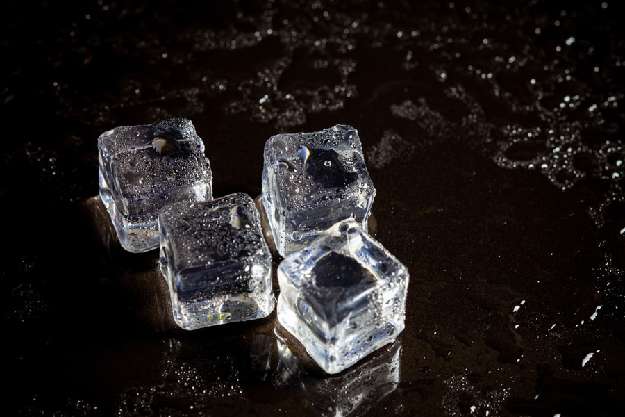 Ice Cubes Reflection On Black Table Background