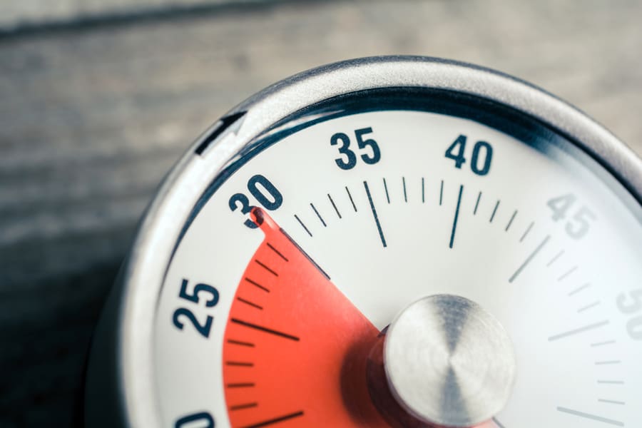 Macro Of An Analog Timer On A Wooden Floor