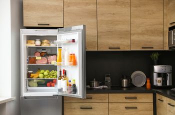 Open Refrigerator Full Of Products In Kitchen