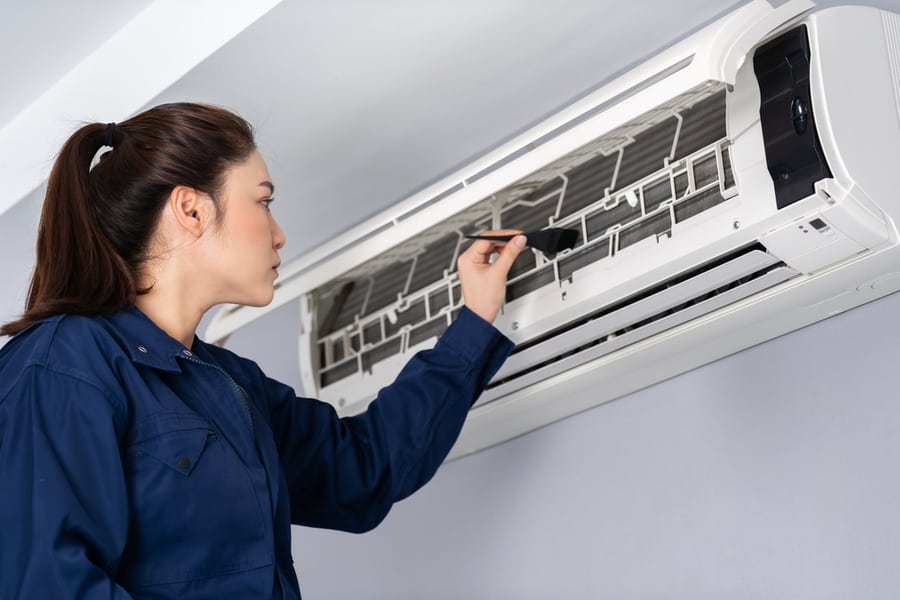 Technician Service Using Brush To Cleaning The Air Conditioner Indoors
