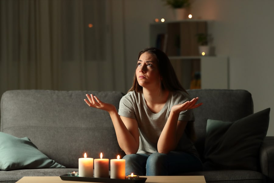 Woman Complaining During A Blackout Sitting On A Couch In The Living Room At Home