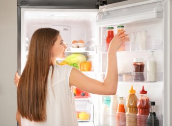 Woman Getting Something From The Refrigerator