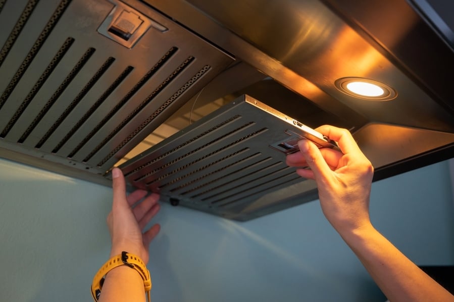 Woman Hands Removing Oven Vent Filters