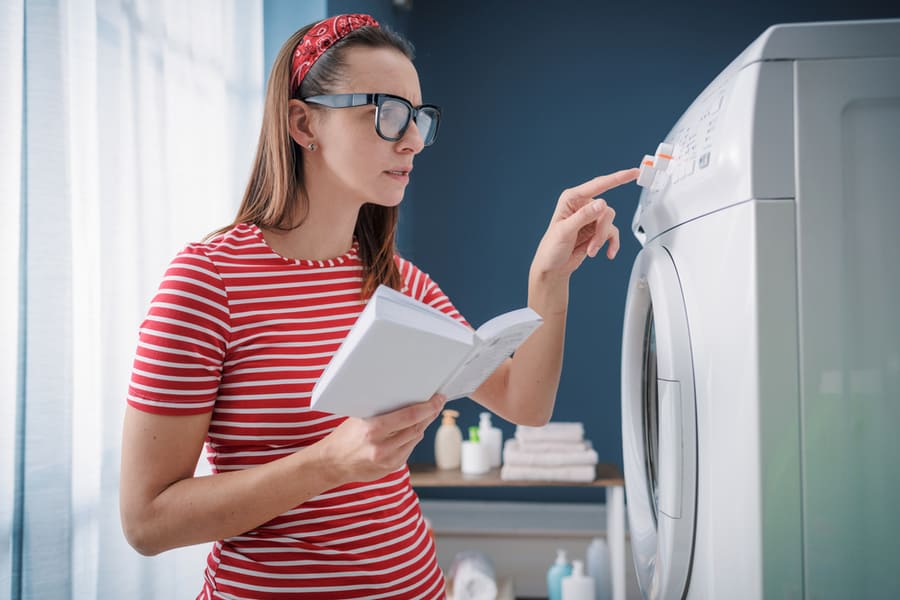 Woman Learning How To Use Her Washing Machine