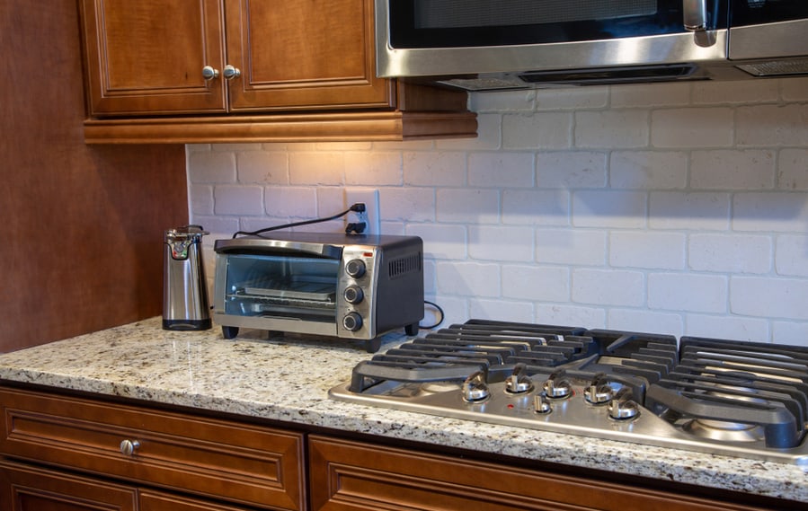 A Modern Kitchen Counter Of Granite With Can Opener