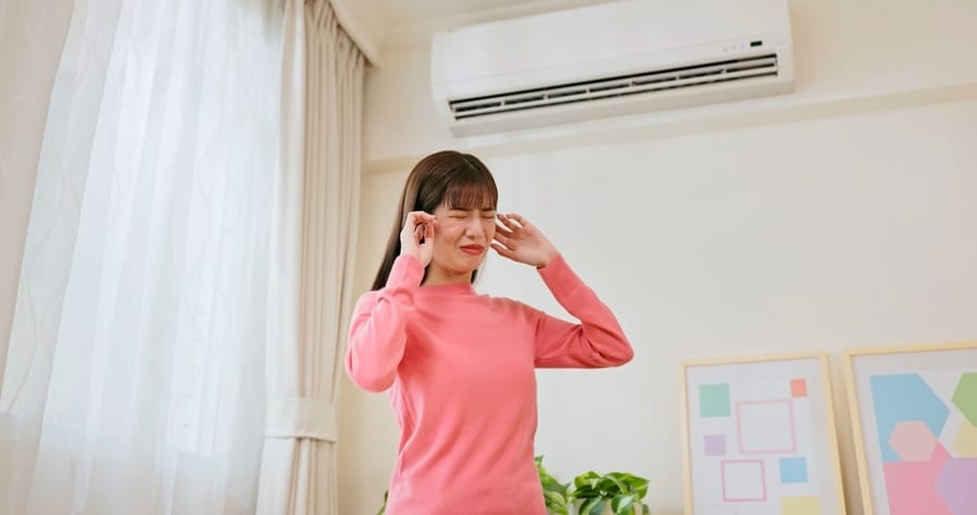 Asian Woman Feel Annoyed And She Is Suffering Noise From Heating At Home - Trying Covering Her Ears