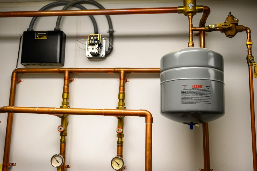 Blue Thermal Water Expansion Tank Connected To Copper Piping