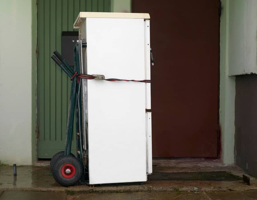 Brand New Unboxed Fridge On A Trolley Next To The House Entrance