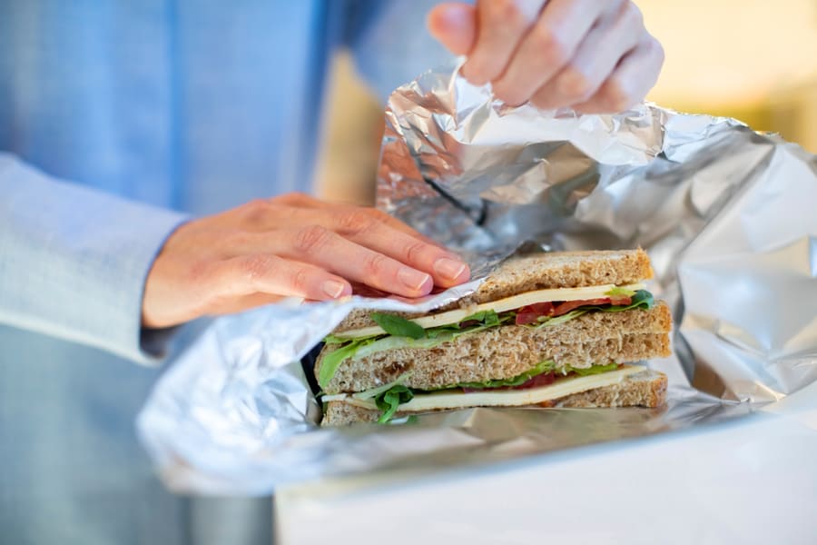 Close Woman Wrapping Sandwich