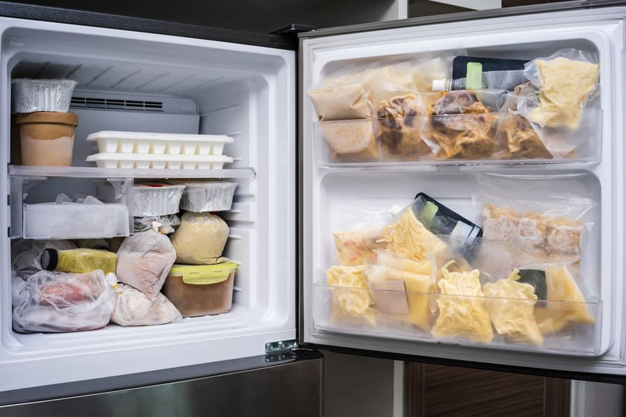 Freezer Of Modern Frigerator Full With Frozen Food Products