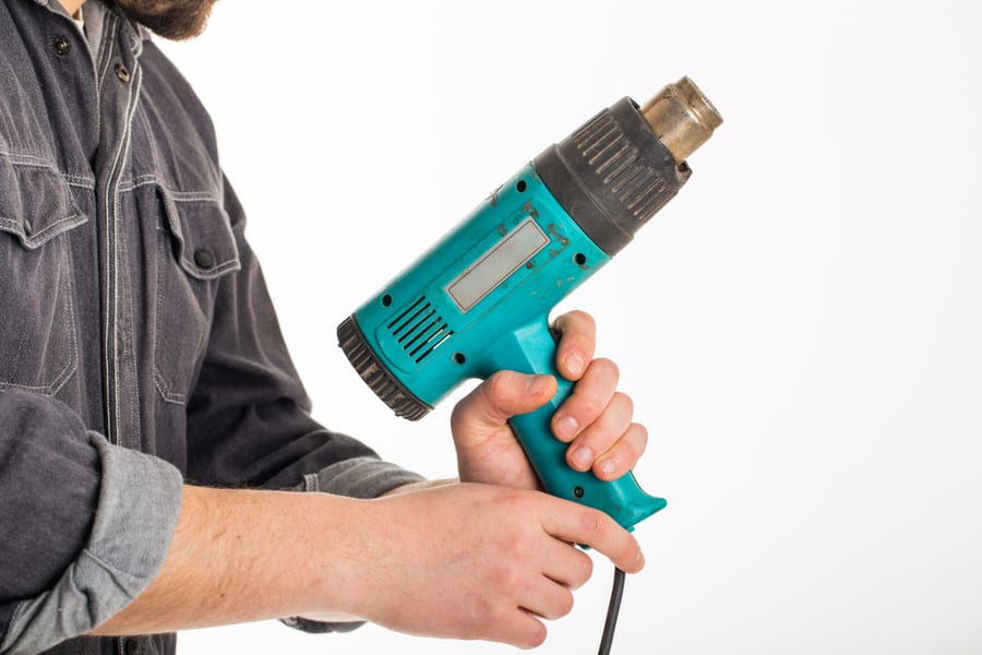 Hand Male Holding Up A Heat Gun On White