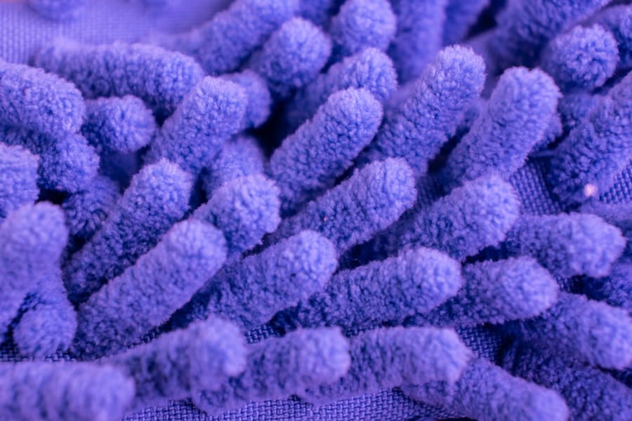 Macro Close Up Of Purple Microfiber Texture For Cleaning And Trapping Dust. Micro Fiber Duster Closeup With Fibers Textures - Soft Machine Washable Material. Reusable Synthetic Fabric, Cleans