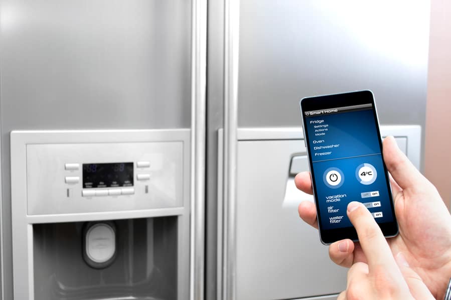 Man Using His Phone To Control The Fridge