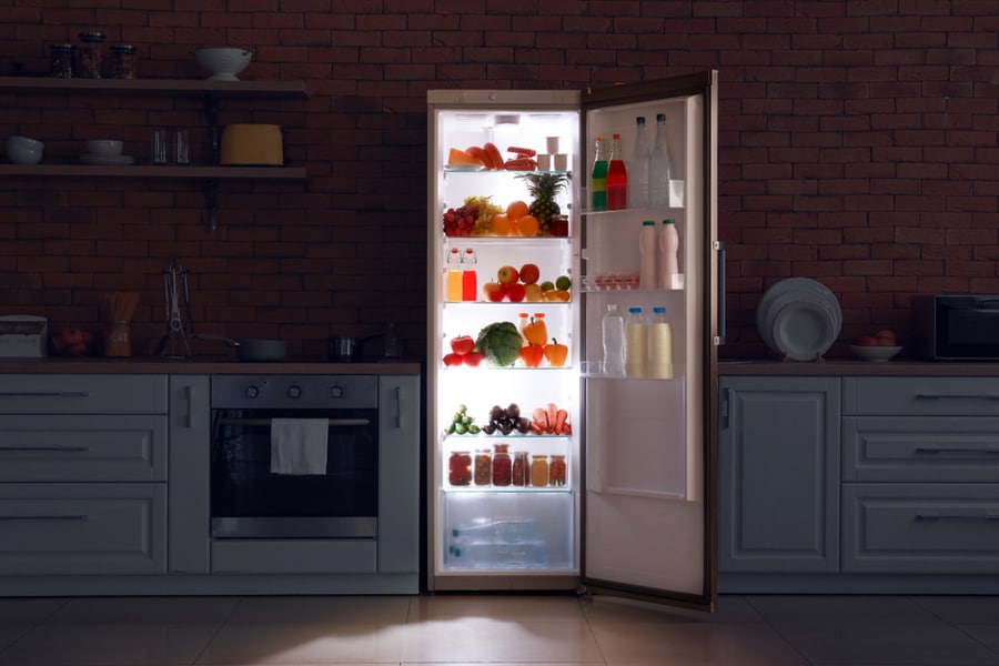 Open Refrigerator In Dark Modern Kitchen