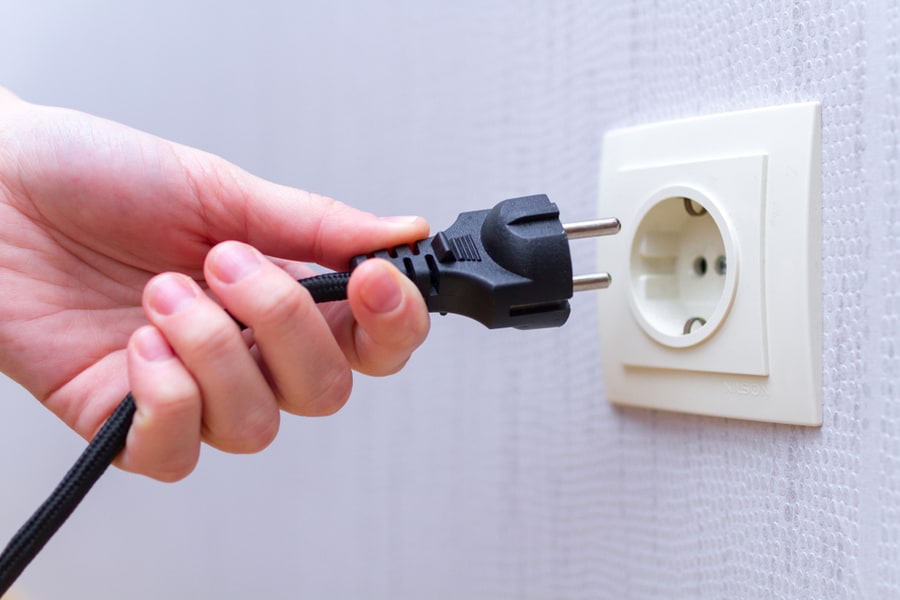 Plugging Electrical, Black Plug In Electric Socket On Wall