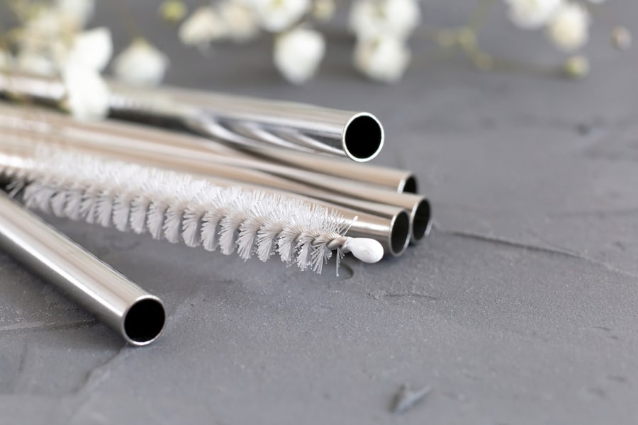 Reusable Metal Straws For The Drinks With A Cleaning Brush On A Gray Background. Concept Of An Eco-Friendly Lifestyle. Toning. Selective Focus.