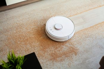 Robot Vacuum Cleaner Performs Automatic Cleaning Of The Apartment At A Certain Time. Smart Home.
