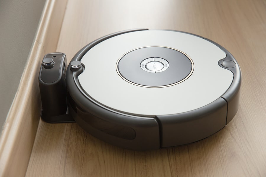 Robot Vacuum Cleaner Return To Charging At Dock In Clean Room Floor