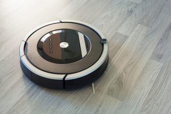 Robotic Vacuum Cleaner On Laminate Wood Floor Smart Cleaning Technology