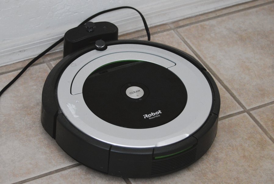 Roomba Robotic Vacuum Cleaner Sits On A Charging