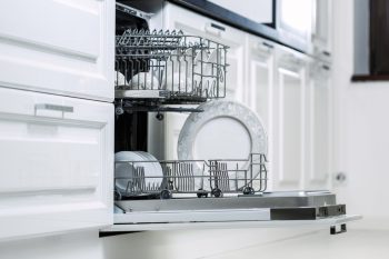 Stack Of Kitchenware In Open Dishwashing Machine