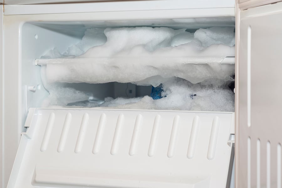 The Fridge Freezer Is Covered With A Thick Layer Of Ice