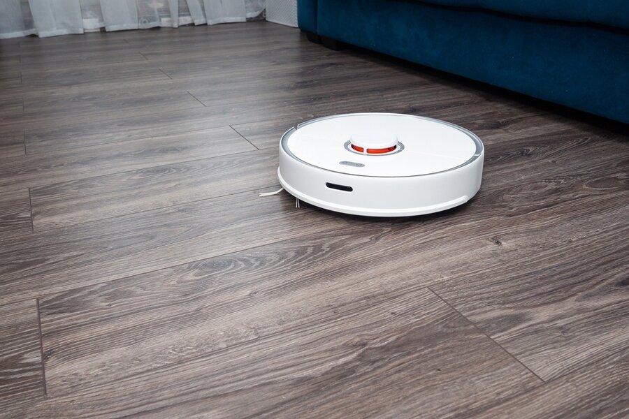 Vacuum Cleaner Robot On A Laminated Wooden Floor