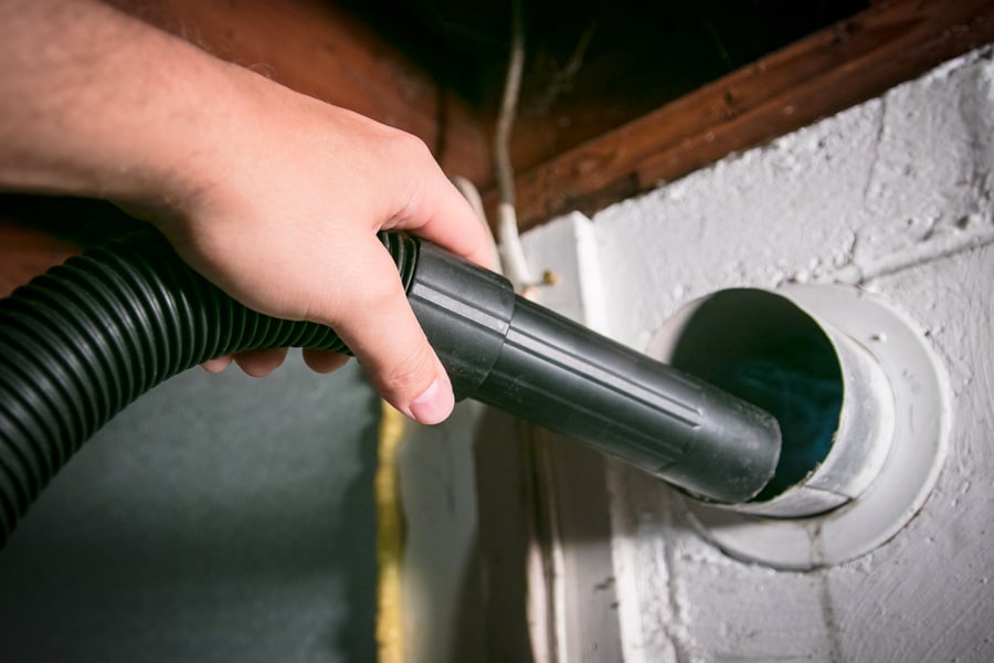 Vacuum Cleaning Out Dryer Vent To Remove Built Up Lint Hazard