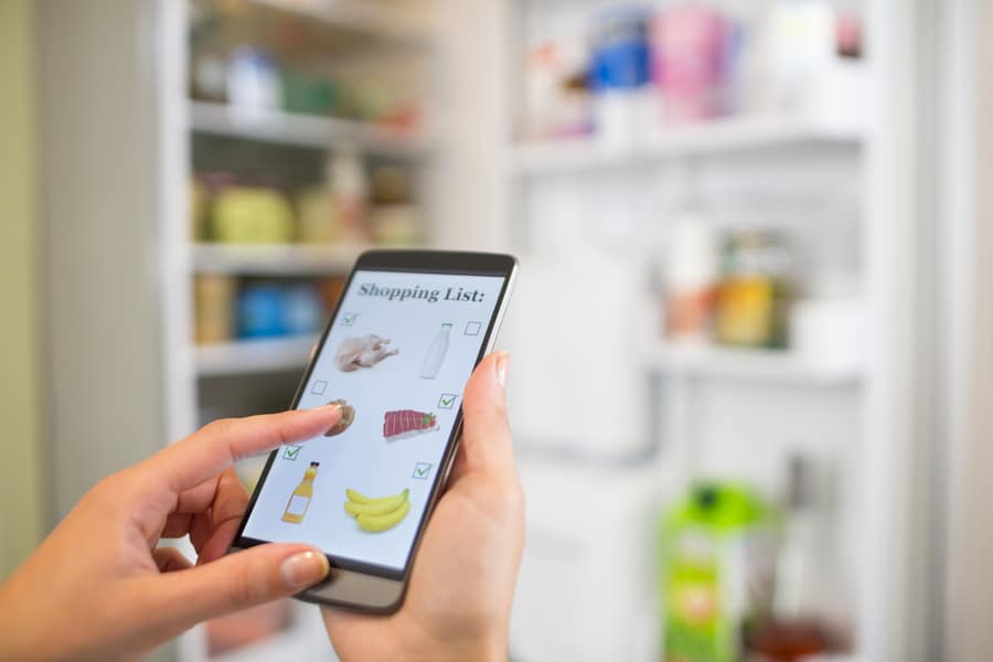 Woman Checking The Grocery List On Her Phone