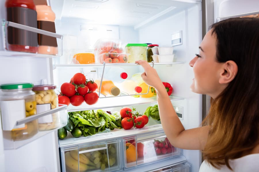 Woman Getting Food From The Fridge