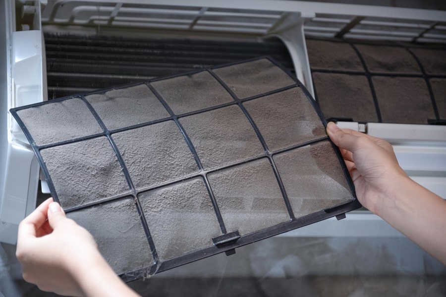 Woman Hand Holding Dirty Home Air Conditioner Filter For Remove For Cleaning Air Conditioner.