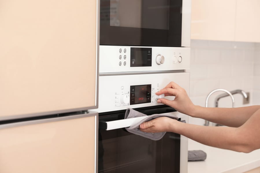 Woman Using Convection Microwave Oven