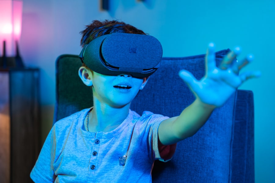 Young Kid With Vr Or Virtual Reality Headset Feeling Or Enjoying The 360 Degree Virtual Environment