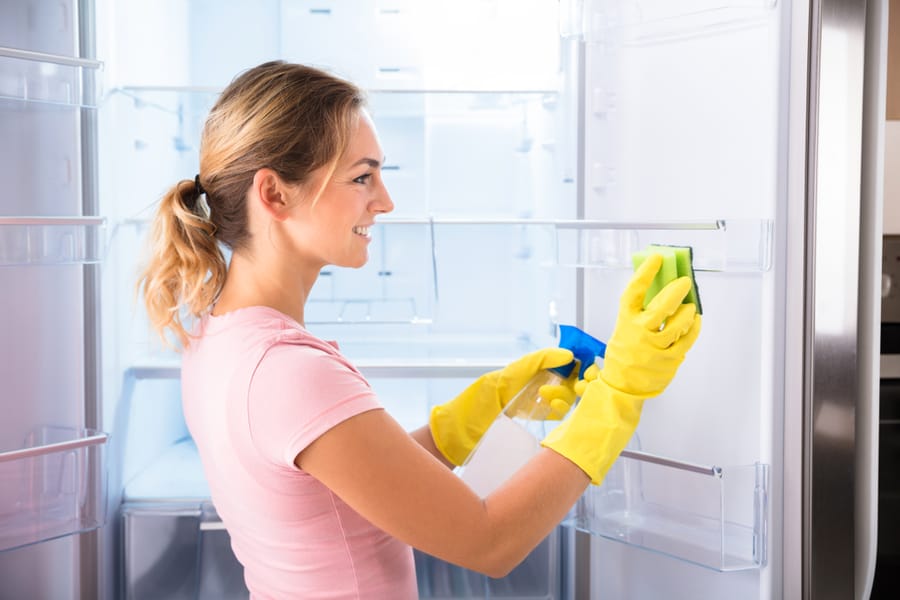 A Woman Cleaning The Fridge