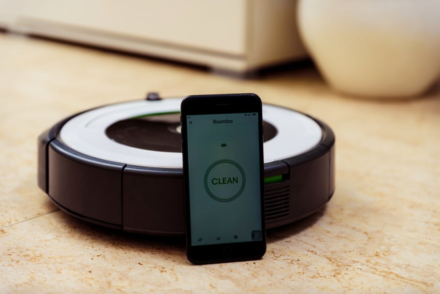 Activation Of The Irobot Vacuum Cleaner Roomba From The Application. Smart Life Concept, Smart City, Smart Home.