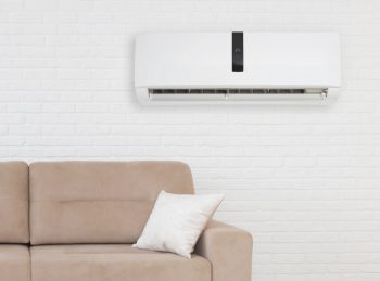 Air Conditioner With Temperature Display Above Sofa In Living Room