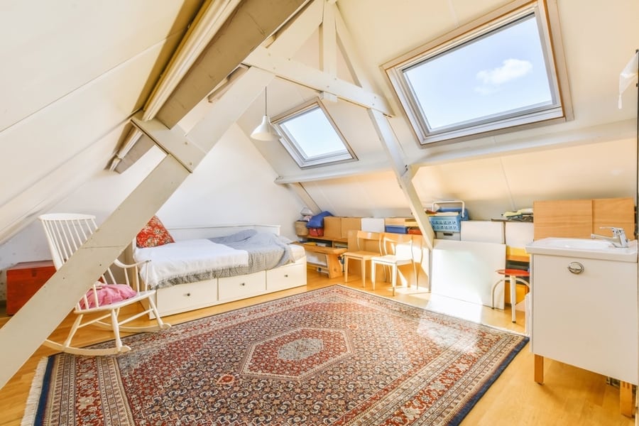 An Attic Bedroom With Skylights Above The Bed And Desk Area In Front Of The Room On The Right Side