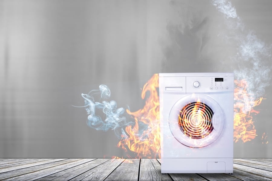 Broken White Washing Machine With Smoke And Fire