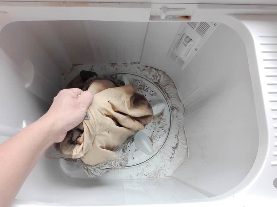 Dirty Sweater In The Tank Of The Washing Machine With Sand And Dust Come Out A Lot.