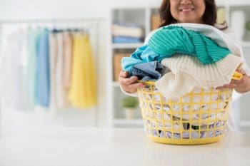 Housewife With Big Basket Of Freshly Washed Clothes
