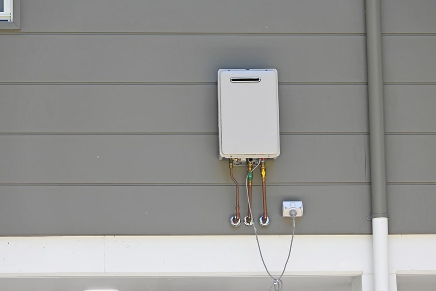 Instantaneous Gas Hot Water Heater On The Side Of A House