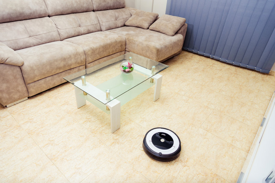 Irobot Roomba Cleaning The Floor Of The Room. Vacuum Cleaner Robot. Household Cleaning Concept. New Technologies.