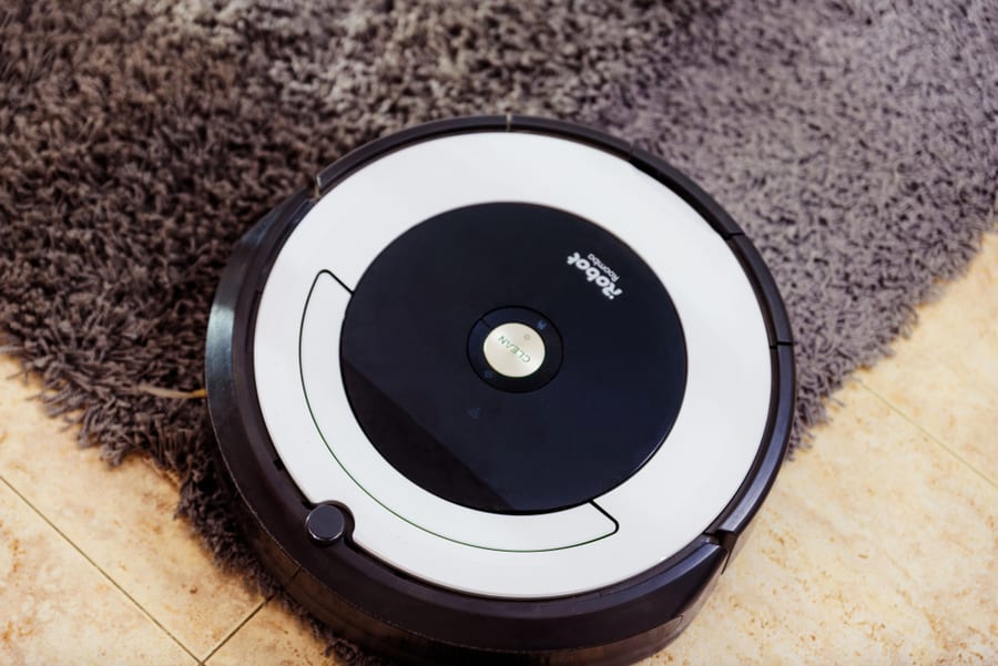 Irobot Vacuum Cleaner Roomba Cleaning A Gray Carpet. Home Cleaning Concept.
