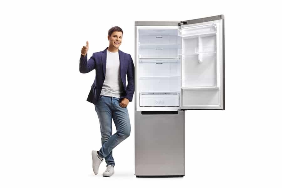 Man Leaning On An Empty Open Fridge And Showing Thumbs Up