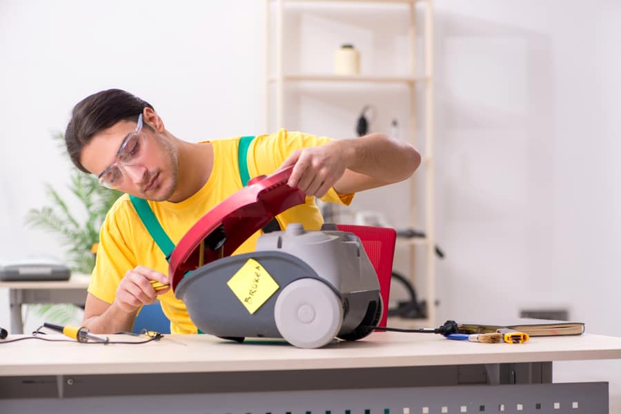 Man Repairman Repairing Vacuum Cleaner