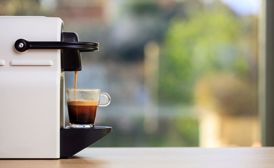 Morning Capsule Coffee. Espresso Maker Machine On A Wooden Table.