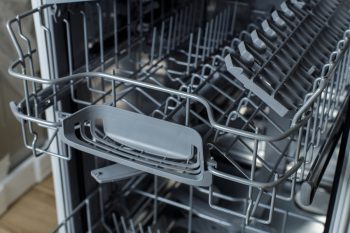 Open Dishwasher. Racks And Dishwasher Containers.