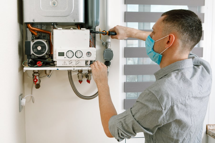 Plumber Attaches Trying To Fix The Problem With The Residential Heating Equipment