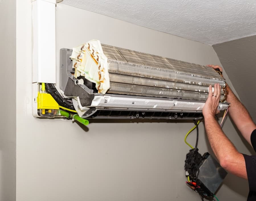 Repairman Working On Air Conditioner Mini-Split System